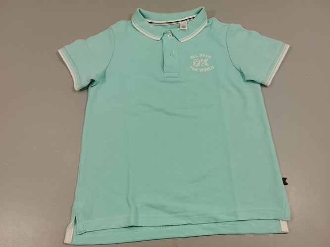 Polo m.c  bleu turquoise clair "all over the world". Toute petite tache  dessus droit, moins cher chez Petit Kiwi