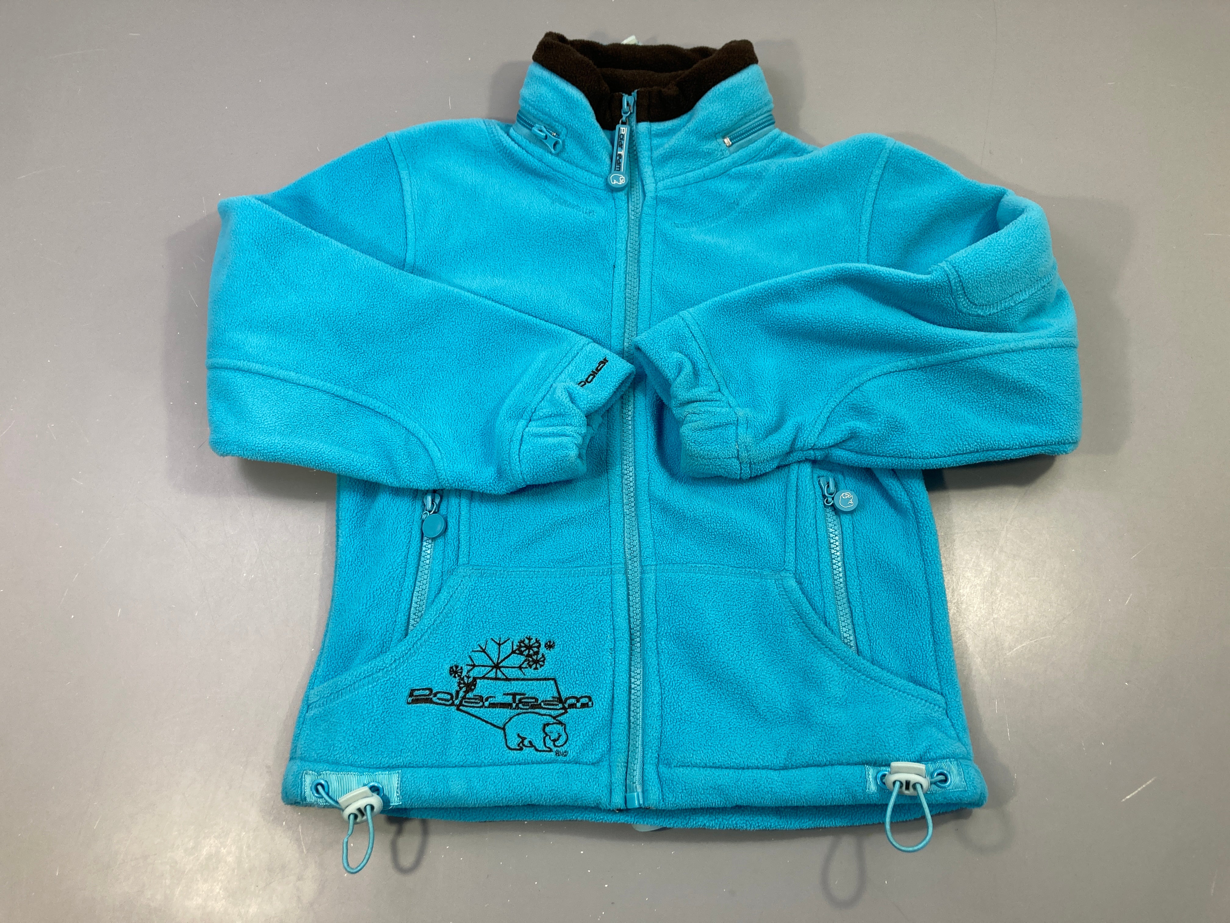 Polar zippé turquoise avec capuche rétractable à zipper ds le col Poalr Team