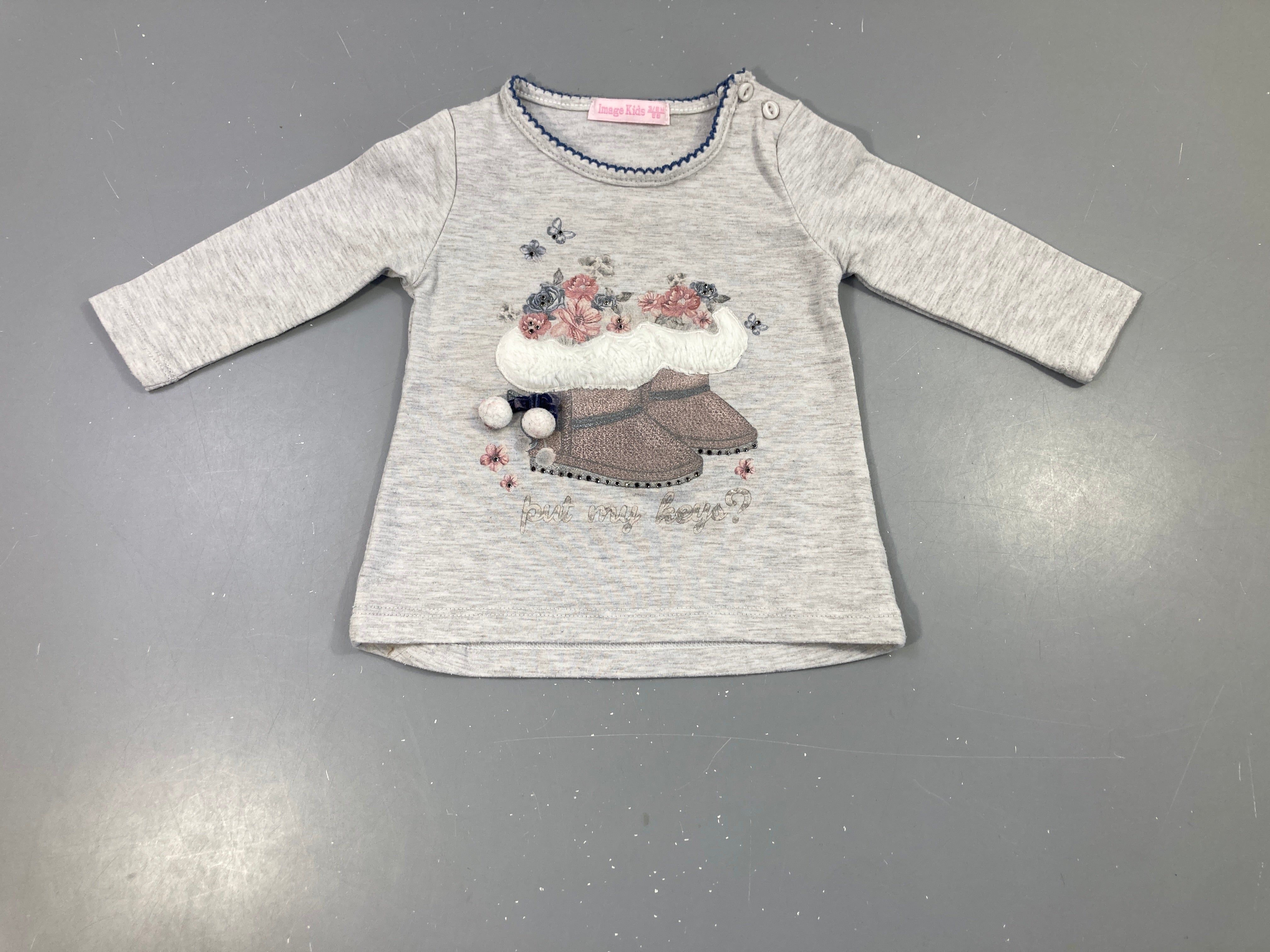 T-shirt m.l gris clair flammé, motif botte de neige avec pompons et petits strass. Légèrement bouloché