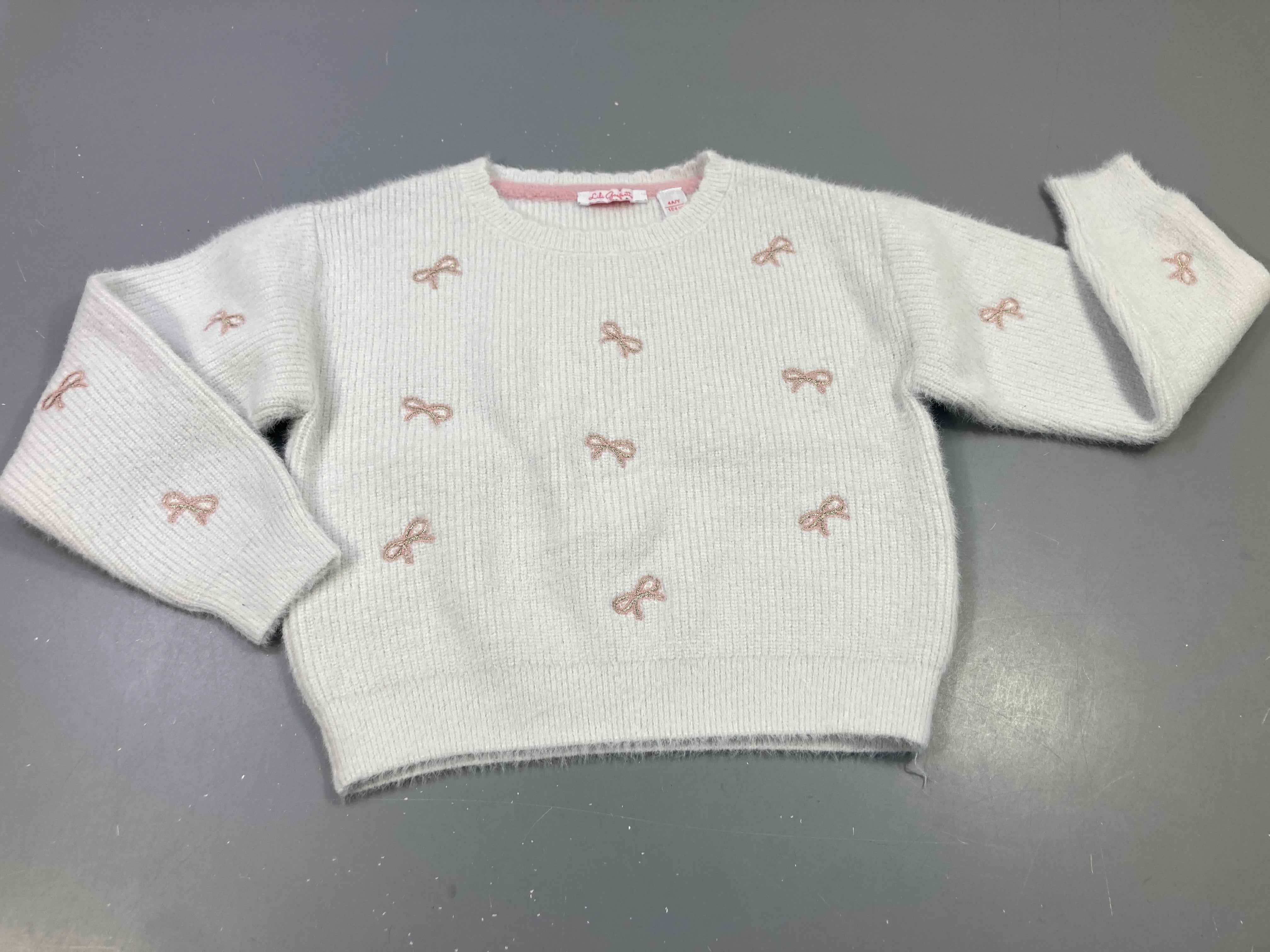 Pull écru noeuds rose et argenté