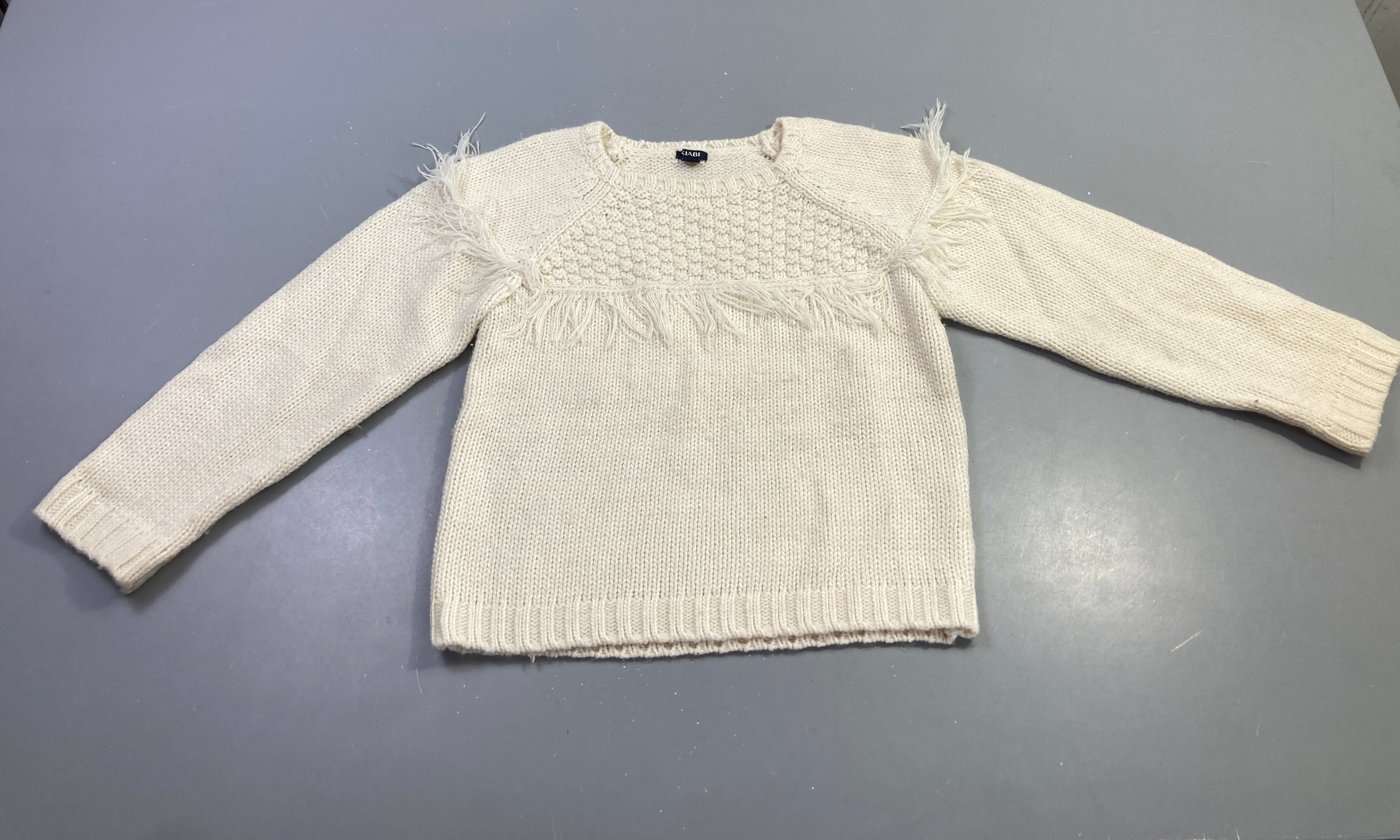 Pull écru franges