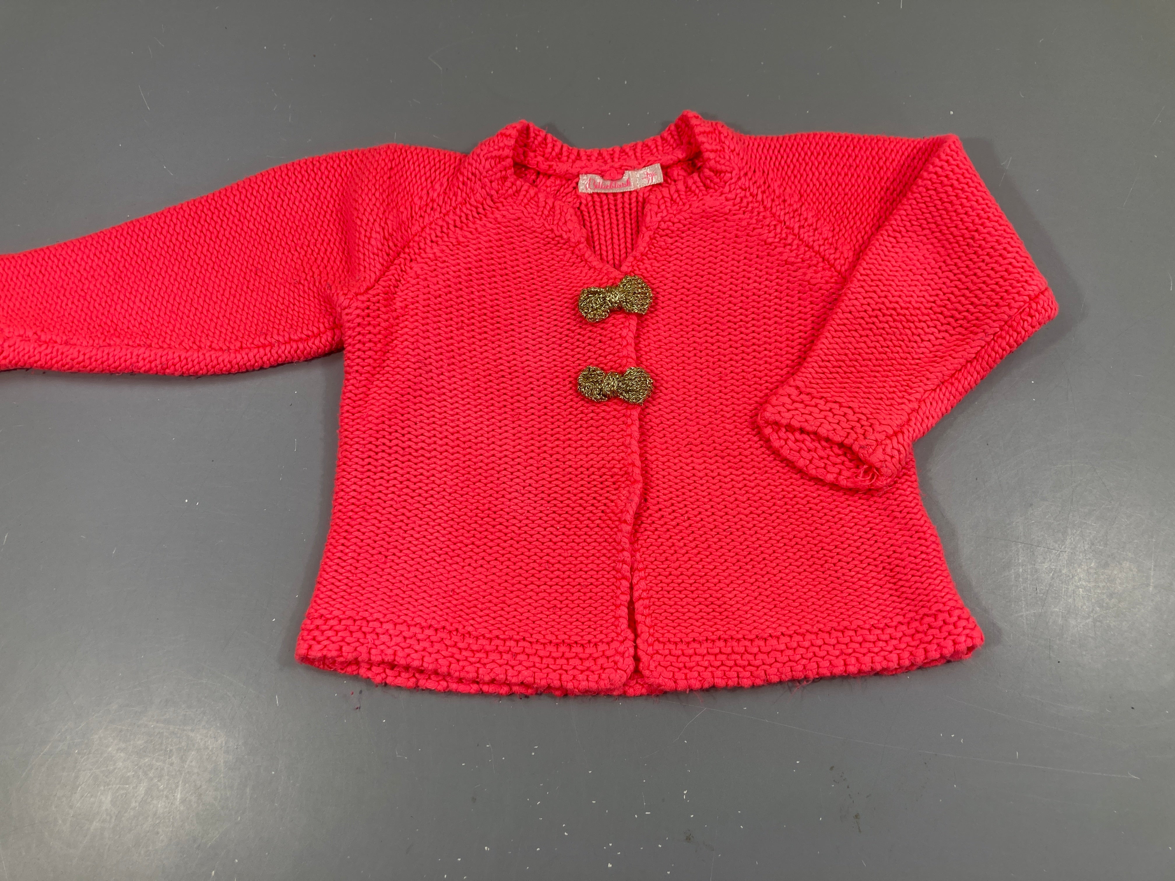 Gilet mailles rose vif noeud doré