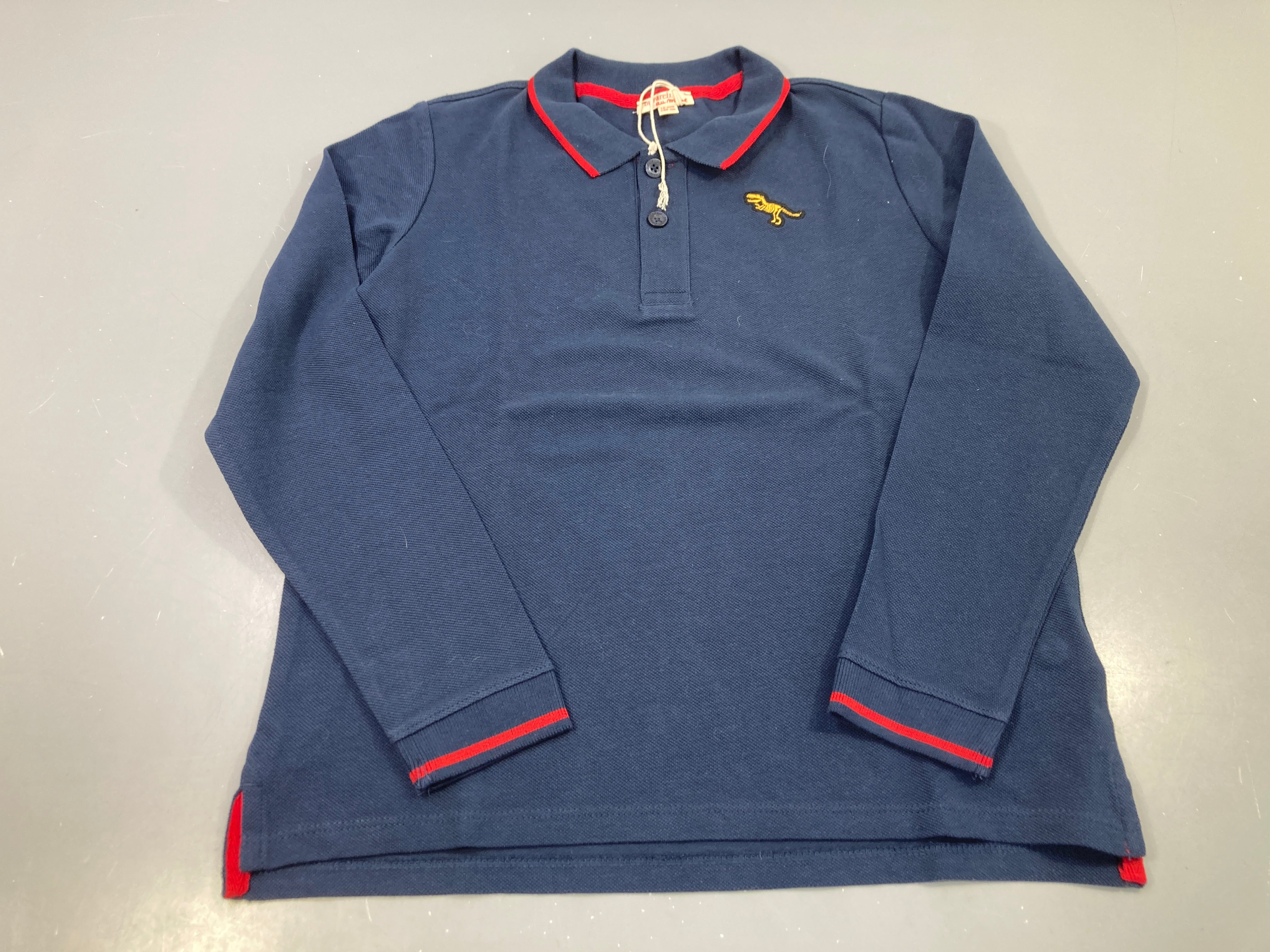 Etat neuf-Polo m.l bleu marine dinosaure brodé