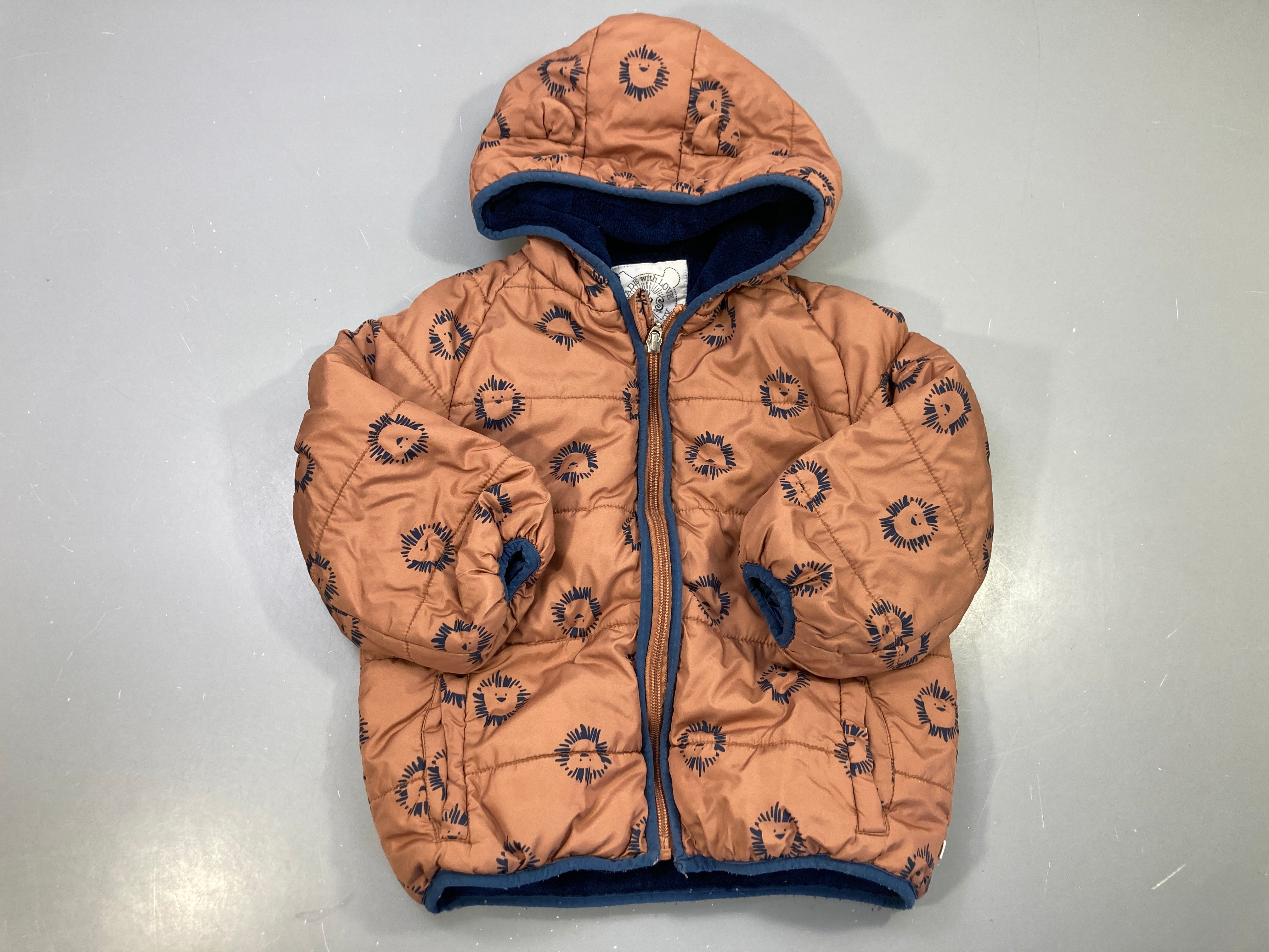 Doudoune rouille lions, capuche oreilles, doublure polaire marine, zippée