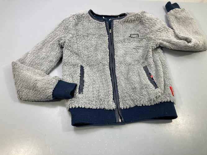 Gilet zippé réversible  bleu marine feuilles blanches/ peluche gris légèrement bouloché,  pas de taille indiquée, estimée 6a, moins cher chez Petit Kiwi