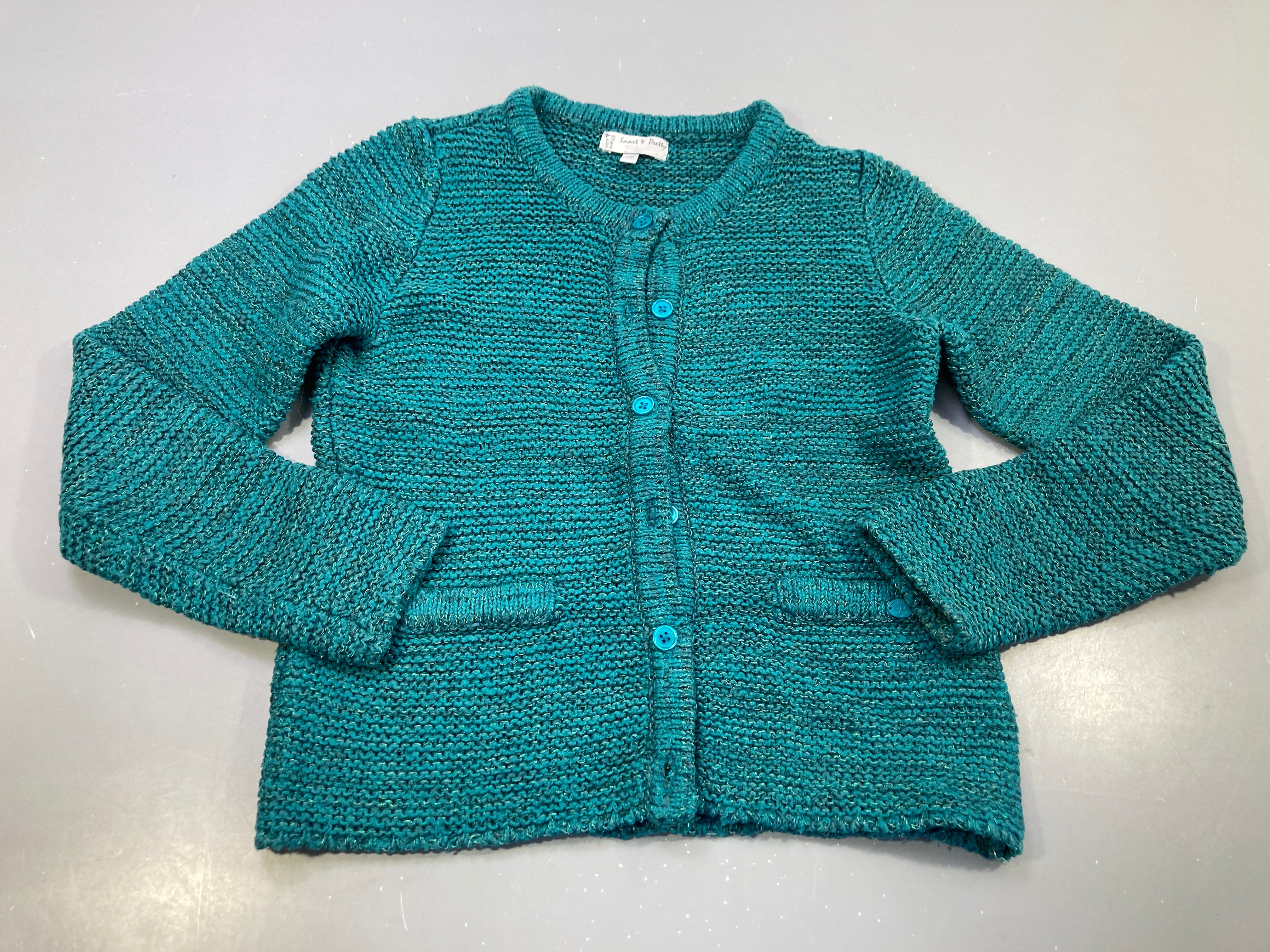 Gilet tricot turquoise avec fils métalliques.
